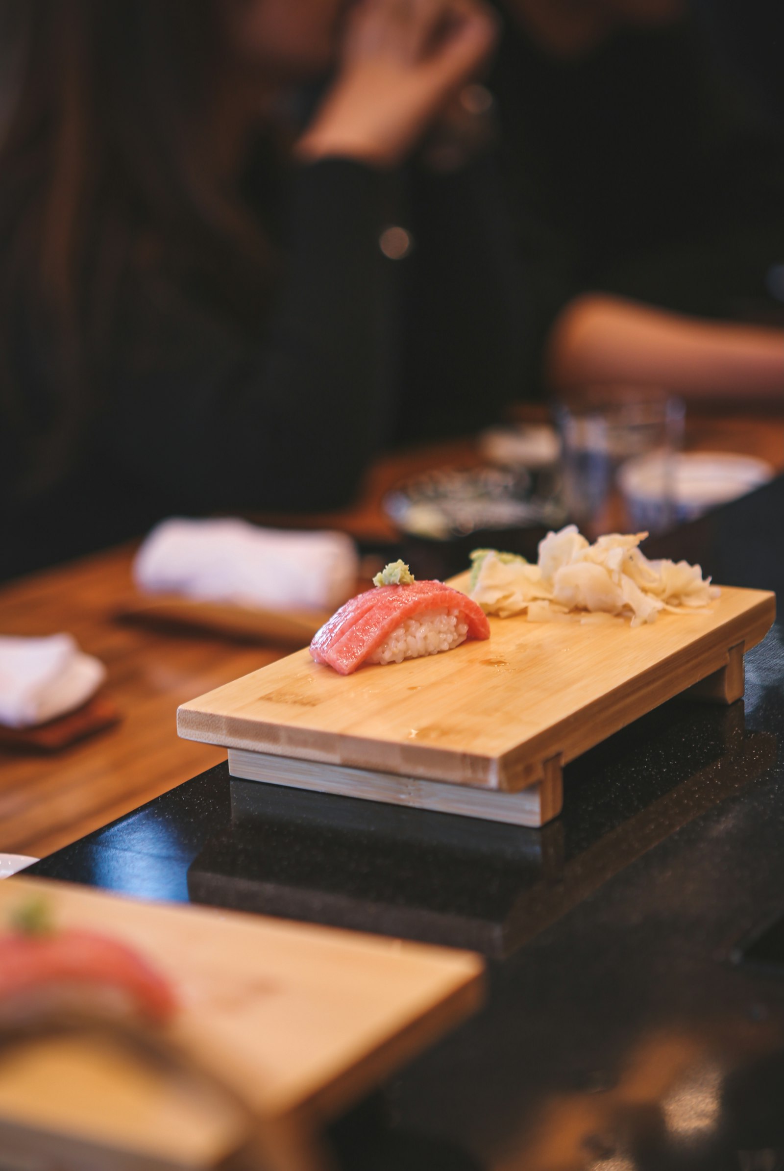 Tuna nigiri on a wooden geta