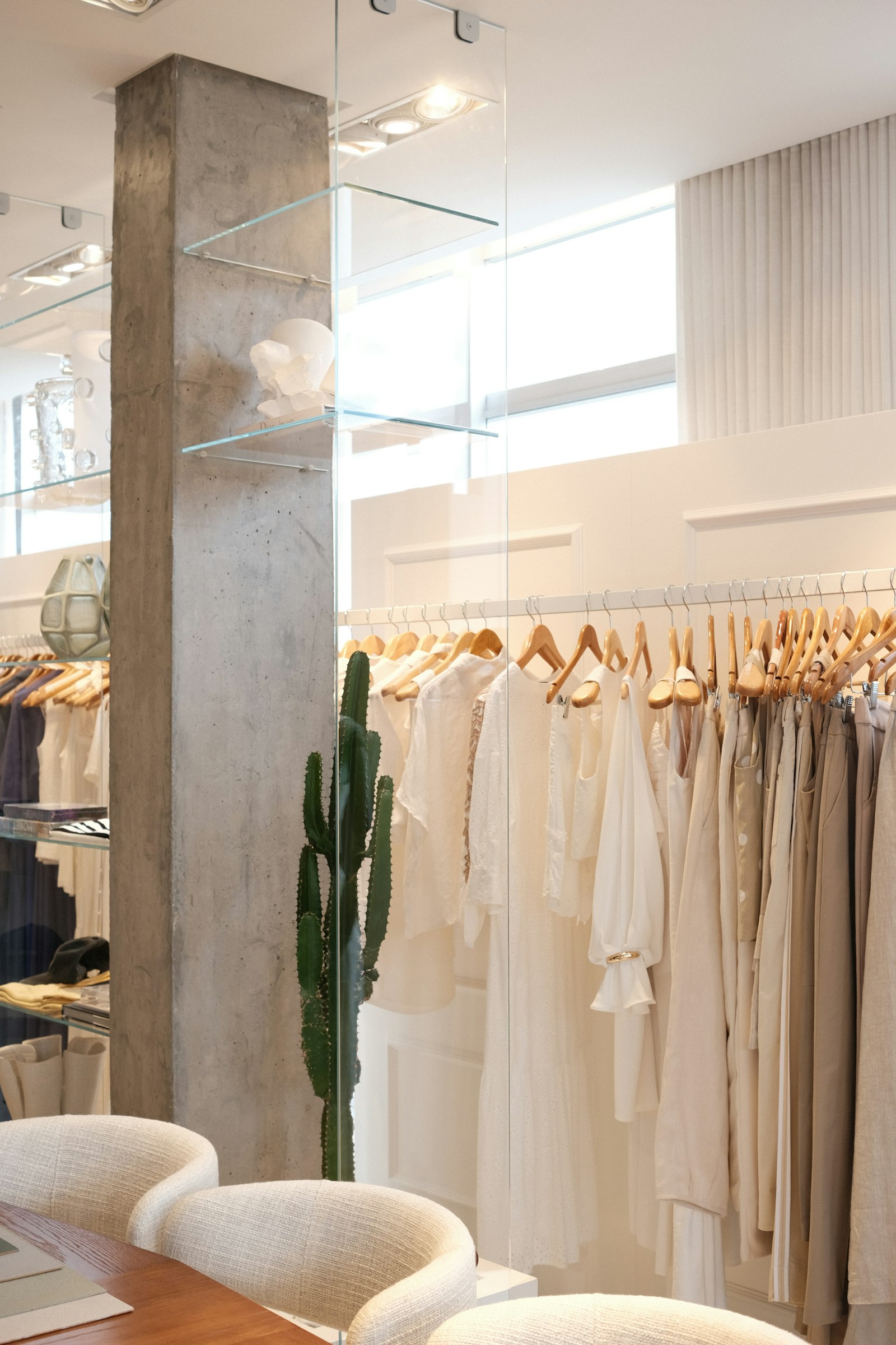 Cream and white dresses on wooden hangers