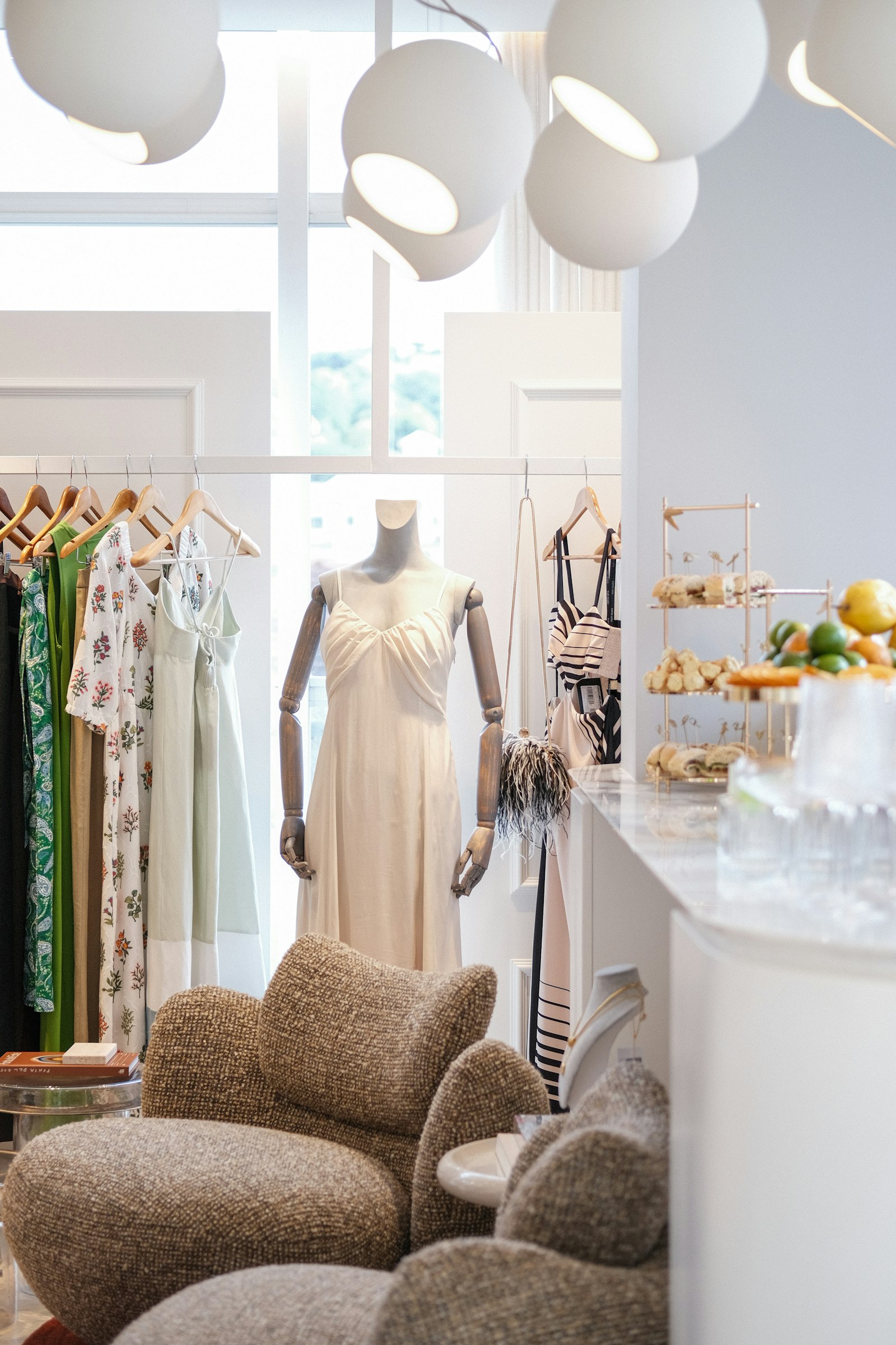 A bright boutique with a slip dress on a wooden mannequin