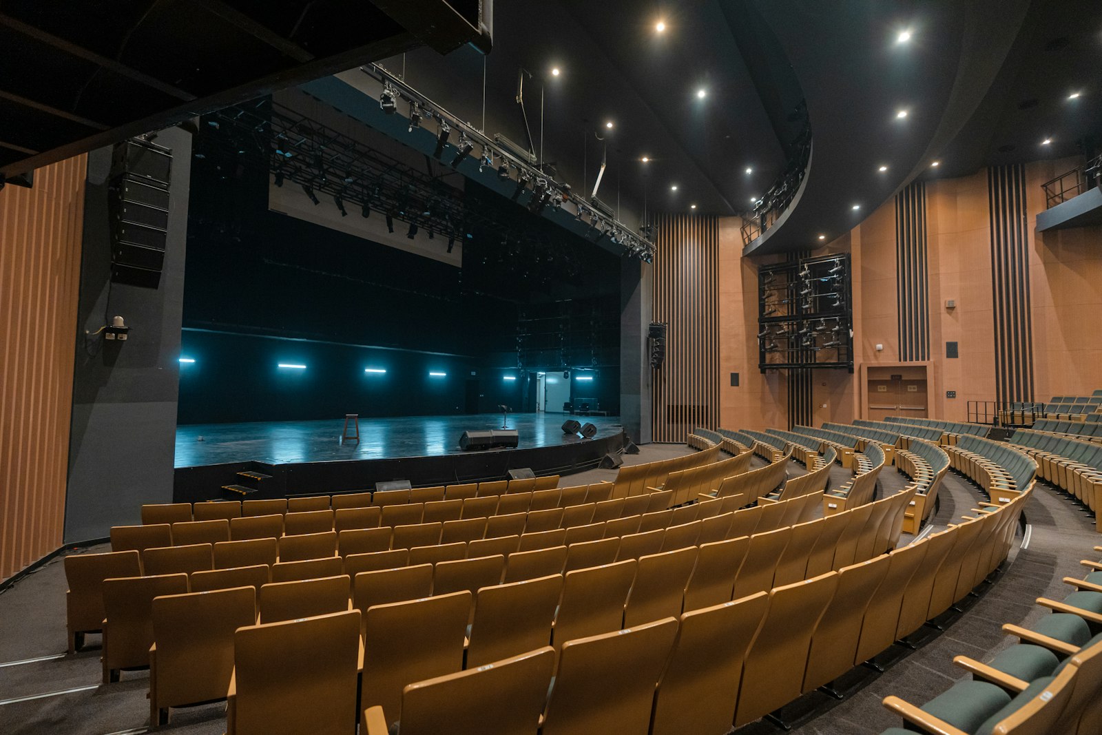 An empty auditorium with wooden seats