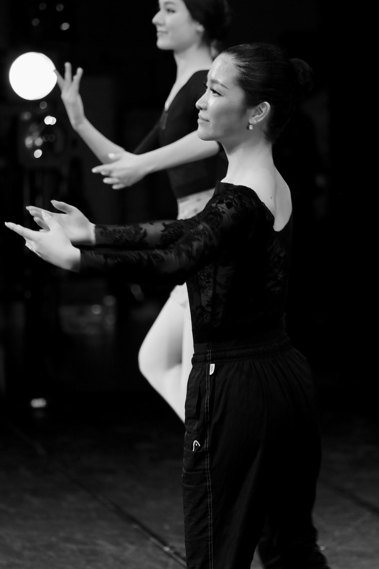 Two women rehearsing in the studio, black and white