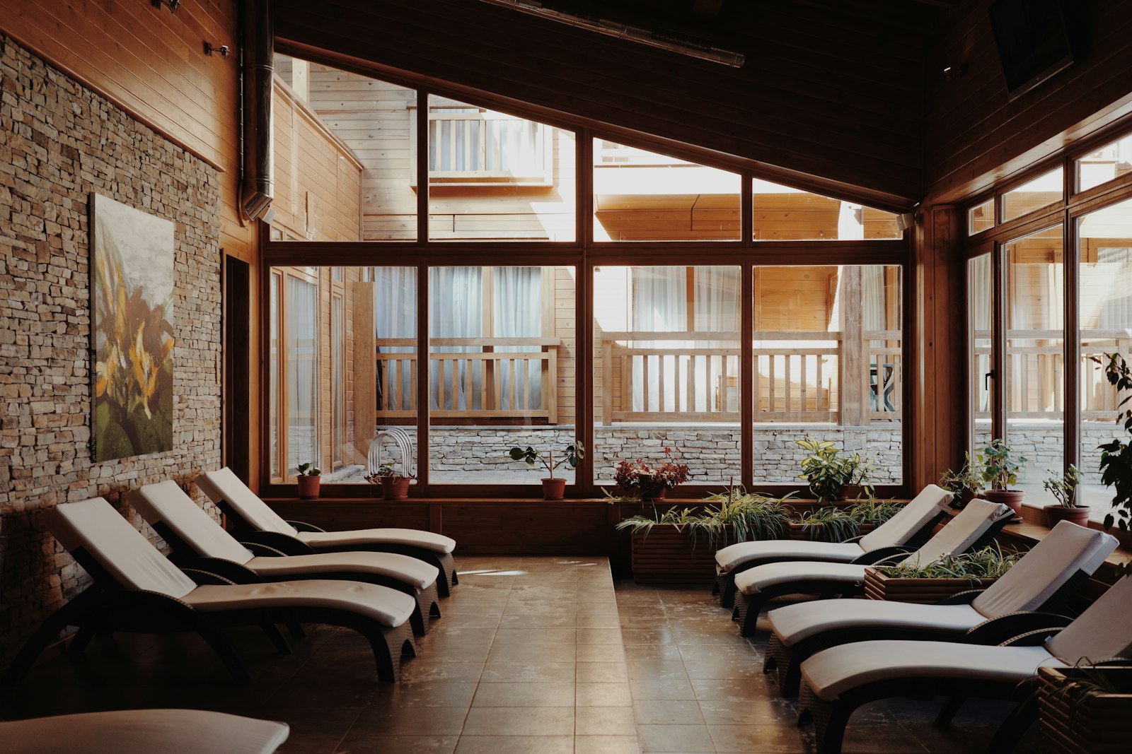 The relaxation lounge, a row of padded loungers and large windows