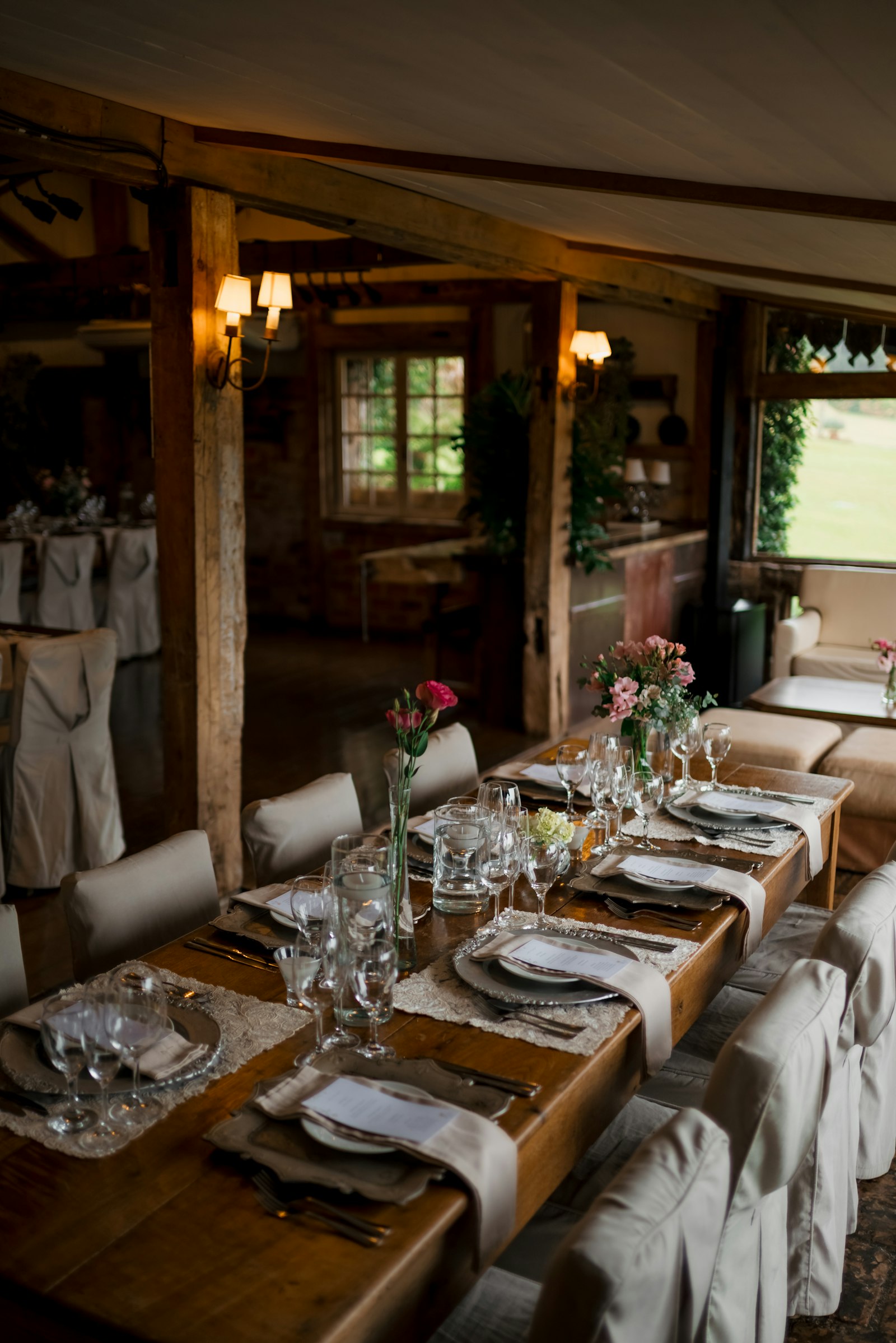 A long rustic dinner table in a beamed room