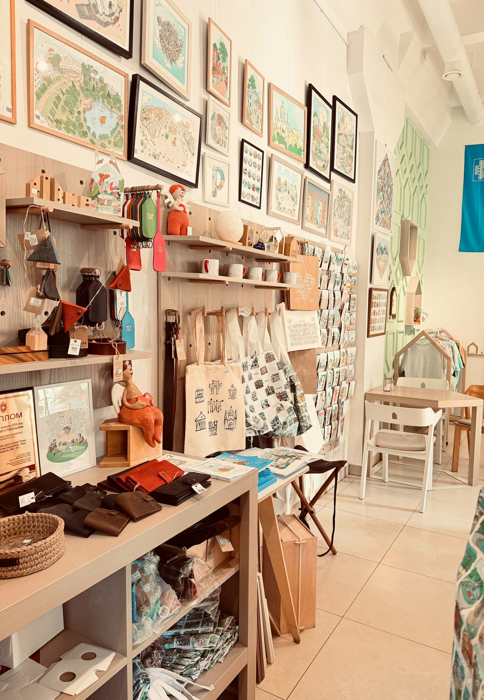 Framed prints and tote bags in a gift shop