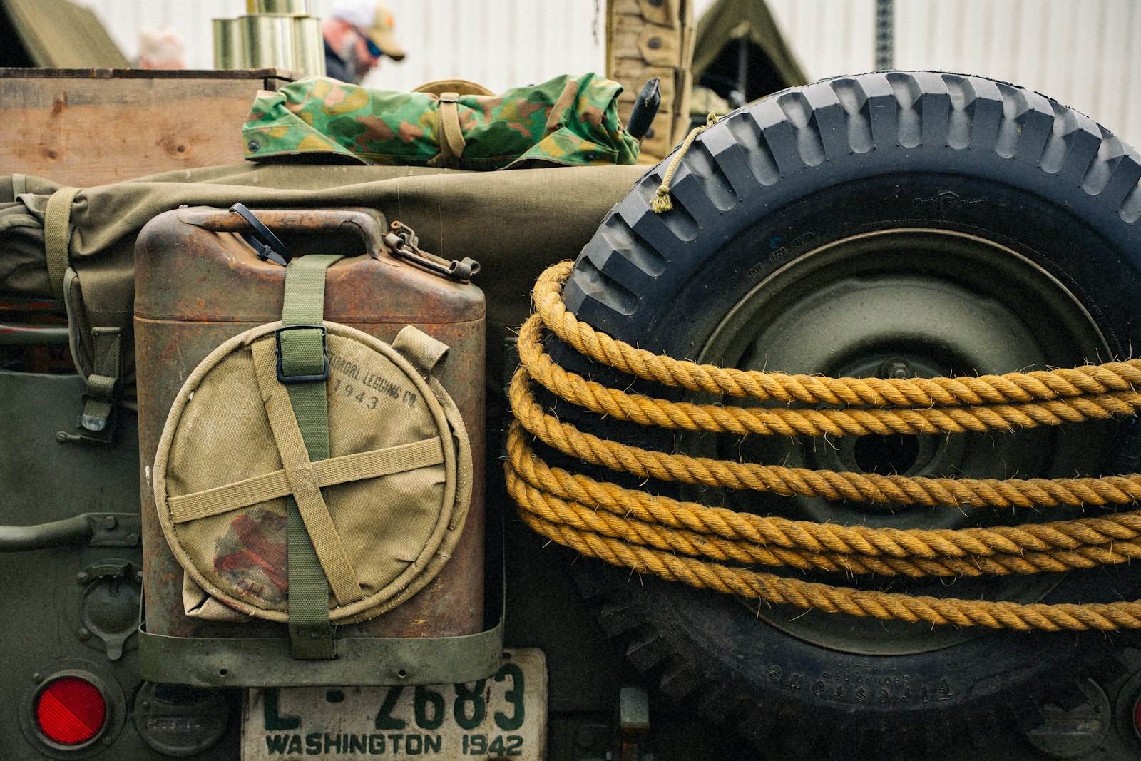 The back of a vehicle with a jerry can, spare wheel and coiled rope