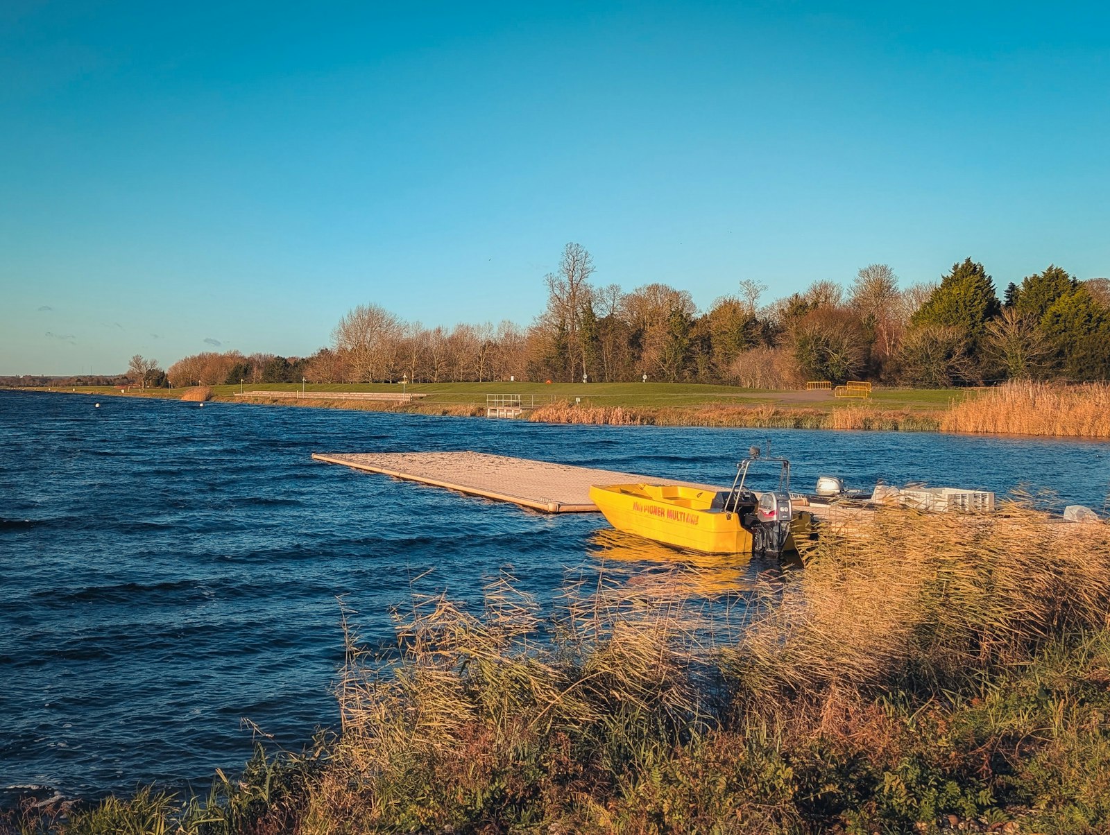 A yellow motorboat at a floating pontoon